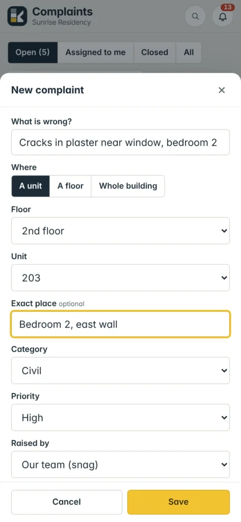 Logging a snag on unit 203 from a phone: cracks in plaster, bedroom 2 east wall, Civil, High.